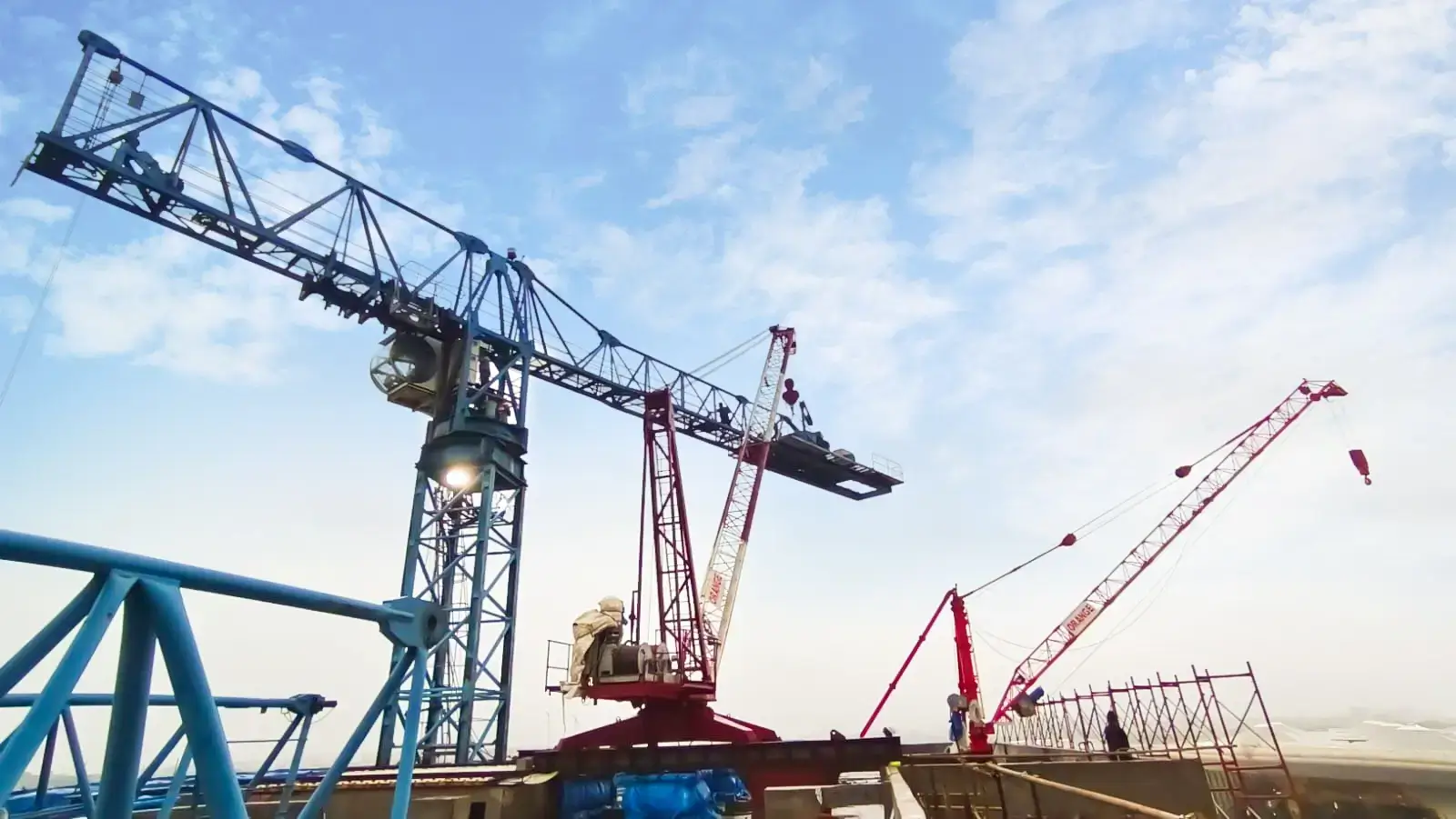 Derrick crane being used at an industrial construction site